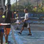 
              In this photo provided by Sam Jalloh, children in Sierra Leone participate in a tennis lesson in October 2021. Jalloh zig-zagged across West Africa in 2021 coaching tennis to kids. He took with him rackets, balls and a cellphone loaded with photos and videos of a pro player in action to inspire the youngsters. The player was new U.S. tennis star Frances Tiafoe. The move to encourage young Africans by showing them images of Tiafoe, an American with Sierra Leone heritage, has paid off big time. (Sam Jalloh via AP)
            