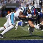 
              Carolina Panthers' Jeremy Chinn, left, tries unsuccessfully to stop New York Giants' Daniel Bellinger from scoring a touchdown during the second half an NFL football game, Sunday, Sept. 18, 2022, in East Rutherford, N.J. (AP Photo/John Munson)
            