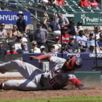 
              Washington Nationals' Josh Palacios (68) slides safely home in the fifth inning of a baseball game against the Atlanta Braves, Wednesday, Sept. 21, 2022, in Atlanta. (AP Photo/Brynn Anderson)
            