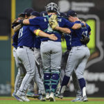 
              Seattle Mariners catcher Cal Raleigh, relief pitcher Matthew Festa, first baseman Ty France and others celebrate after the Mariners defeated the Cleveland Guardians 6-1 in a baseball game Friday, Sept. 2, 2022, in Cleveland. (AP Photo/David Dermer)
            