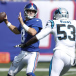 
              New York Giants quarterback Daniel Jones, left, looks to throw during the first half an NFL football game against the Carolina Panthers, Sunday, Sept. 18, 2022, in East Rutherford, N.J. (AP Photo/Noah K. Murray)
            