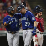 
              Seattle Mariners' Cal Raleigh, front right, is congratulated by Carlos Santana after hitting three-run home run off Cleveland Guardians relief pitcher Bryan Shaw during the sixth inning of a baseball game Friday, Sept. 2, 2022, in Cleveland. (AP Photo/David Dermer)
            