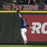 
              Seattle Mariners right fielder Mitch Haniger catches at the wall the ball hit by Texas Rangers' Josh H. Smith during the eighth inning of a baseball game Thursday, Sept. 29, 2022, in Seattle. (AP Photo/Stephen Brashear)
            