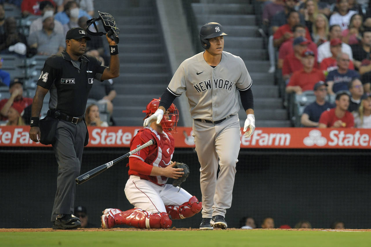 New York Yankees' Anthony Rizzo, right, drops his bat after hitting a solo home run while Los Angel...