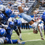 
              North Carolina running back Omarion Hampton dives over the pile for a touchdown in the second half of an NCAA college football game against Georgia State Saturday, Sept. 10, 2022, in Atlanta. (AP Photo/Hakim Wright Sr.)
            