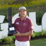 
              Cameron Smith poses with the champion's trophy after winning the LIV Golf Invitational-Chicago tournament Sunday, Sept. 18, 2022, in Sugar Hill, Ill. (AP Photo/Charles Rex Arbogast)
            