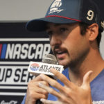 
              FILE - Driver Chase Elliott speaks to the media during a weather delay before qualifying the NASCAR Cup Series auto race at Atlanta Motor Speedway in Hampton, Ga., on Saturday, July 9, 2022. The regular-season champion's day was done early after a wreck at Darlington that sent him tumbling down the playoff standings, leaving Elliott white-knuckling his way into Kansas Speedway for Sunday's second postseason race. (AP Photo/Bob Andres, File)
            