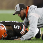 
              Cleveland Browns linebacker Anthony Walker Jr. (5) is checked by a trainer after being injured during the second half of an NFL football game against the Pittsburgh Steelers in Cleveland, Thursday, Sept. 22, 2022. Walker left the game. (AP Photo/Ron Schwane)
            