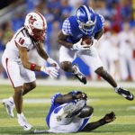 
              Kentucky defensive back Keidron Smith leaps over a teammate while intercepting a pass during the second half of the team's NCAA college football game against Miami (Ohio) in Lexington, Ky., Saturday, Sept. 3, 2022. (AP Photo/Michael Clubb)
            