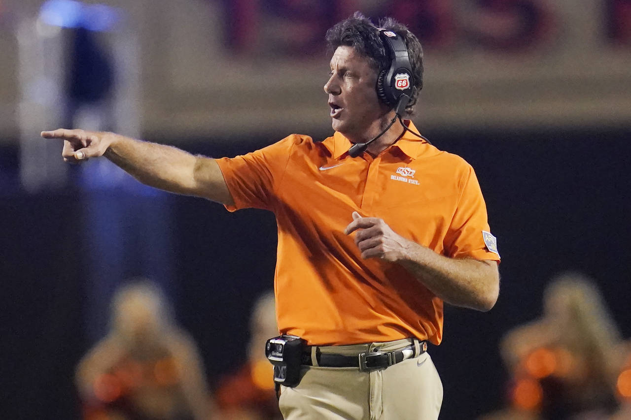 Oklahoma State coach Mike Gundy gestures during the second half of the team's NCAA college football...