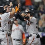 
              From left, San Francisco Giants' LaMonte Wade Jr., and Mike Yastrzemski congratulate Thairo Estrada as he crosses home plate after hitting a three-run home run off Colorado Rockies relief pitcher Gavin Hollowell in the 10th inning of a baseball game Monday, Sept. 19, 2022, in Denver. (AP Photo/David Zalubowski)
            