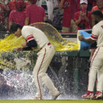 
              Los Angeles Angels' Luis Rengifo, right, tosses liquid at starting pitcher Shohei Ohtani after a baseball game against the Oakland Athletics Thursday, Sept. 29, 2022, in Anaheim, Calif. (AP Photo/Mark J. Terrill)
            