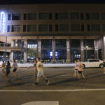 
              Runners pass the new Hotel Tupelo on Main Street as they hold their "Liza's Lights" run early Friday morning, Spet. 9, 2022, in Tupelo Miss., to remember Eliza Fletcher, who was abducted and murdered while she was running in the early morning hours in Memphis, Tenn. (Thomas Wells/The Northeast Mississippi Daily Journal via AP)
            
