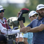 
              Dustin Johnson pulls a driver from his bag during the first round of the LIV Golf Invitational-Chicago tournament Friday, Sept. 16, 2022, in Sugar Grove, Ill. (AP Photo/Charles Rex Arbogast)
            