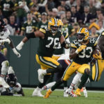 
              Green Bay Packers running back Aaron Jones (33) runs from Chicago Bears linebacker Nicholas Morrow (53) during the second half of an NFL football game Sunday, Sept. 18, 2022, in Green Bay, Wis. (AP Photo/Morry Gash)
            