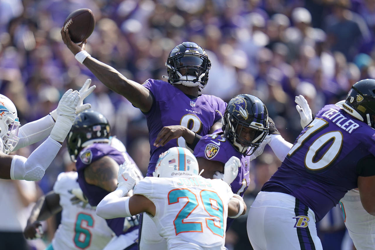 Baltimore Ravens quarterback Lamar Jackson (8) aims a pass during the first half of an NFL football...
