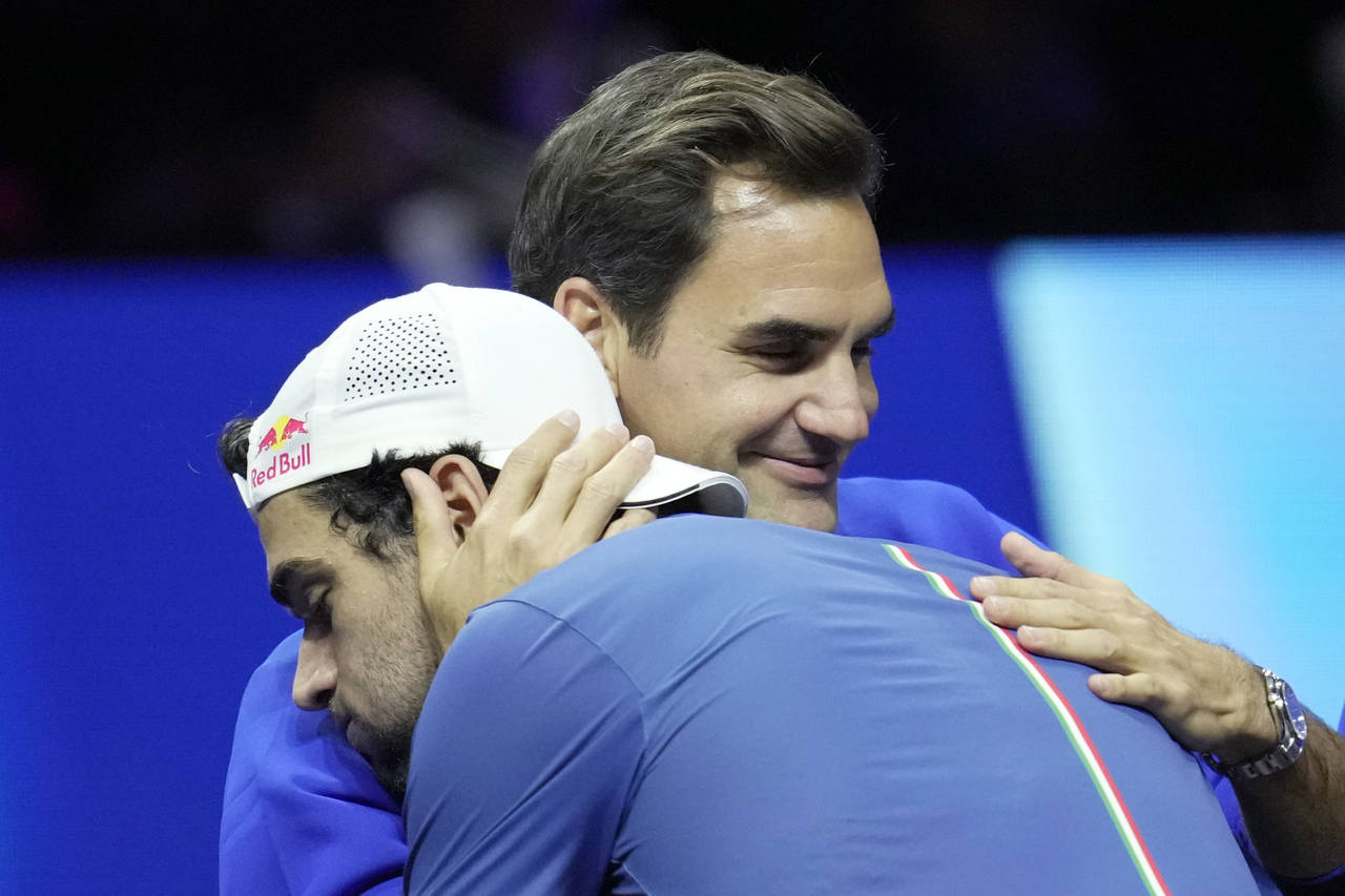 Team Europe's Matteo Berrettini, of Italy, celebrates with Roger Federer of Switzerland, after winn...