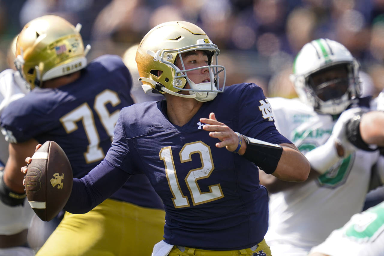 Notre Dame quarterback Tyler Buchner (12) throws against Marshall during the first half of an NCAA ...