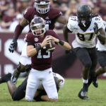 
              Texas A&M quarterback Haynes King (13) is tackled for no gain by Appalachian State linebacker Nick Hampton (9) during the first half of an NCAA college football game Saturday, Sept. 10, 2022, in College Station,Texas. (AP Photo/Sam Craft)
            