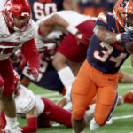 
              Syracuse running back Sean Tucker (34) reaches for the goal line during an NCAA college football game against Louisville in Syracuse, N.Y., Saturday, Sept 3, 2022. (Dennis Nett/The Post-Standard via AP)
            
