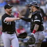 
              Chicago White Sox relief pitcher Liam Hendriks, left, and catcher Yasmani Grandal, right, celebrate after defeating the Minnesota Twins 4-3 in a baseball game Thursday, Sept. 29, 2022, in Minneapolis. (AP Photo/Abbie Parr)
            