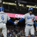 
              Los Angeles Dodgers' Cody Bellinger (35) in congratulated by Trea Turner (6) after scoring against the San Francisco Giants during the tenth inning of a baseball game in San Francisco, Sunday Sept. 18, 2022. (AP Photo/John Hefti)
            