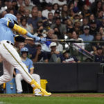 
              Milwaukee Brewers' Christian Yelich hits an RBI triple during the fifth inning of a baseball game against the New York Yankees Saturday, Sept. 17, 2022, in Milwaukee. (AP Photo/Aaron Gash)
            