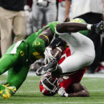 
              Georgia running back Daijun Edwards, right, is stopped by Oregon defensive back Jamal Hill, left, after a short gain in the second half of an NCAA college football game Saturday, Sept. 3, 2022, in Atlanta. (AP Photo/John Bazemore)
            