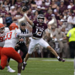 
              Texas A&M quarterback Haynes King (13) throws a pass as Sam Houston State defensive lineman Chris Scott (97) pressures him during the first half of an NCAA college football game Saturday, Sept. 3, 2022, in College Station, Texas. (AP Photo/David J. Phillip)
            