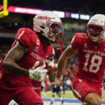 
              Houston wide receiver Nathaniel Dell (1) celebrates with teammate Joseph Manjack IV (18) after his touchdown catch during the second half of an NCAA college football game against UTSA, Saturday, Sept. 3, 2022, in San Antonio. (AP Photo/Eric Gay)
            