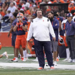 
              Illinois head coach Brent Bielema, center, looks at the scoreboard during the second half of an NCAA college football game against Virginia, Saturday, Sept. 10, 2022, in Champaign, Ill. (AP Photo/Charles Rex Arbogast)
            
