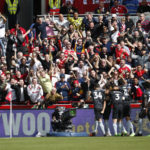 
              Arsenal players celebrates after their tammate Fabio Vieira scored his side's third goal during the English Premier League soccer match between Brentford and Arsenal, at the Gtech Community stadium, London, Sunday, Sept.18, 2022. (AP Photo/David Cliff)
            