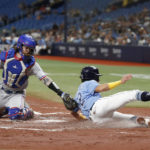 
              Tampa Bay Rays' Jonathan Aranda, right, slides safely past Texas Rangers catcher Jonah Heim to score during the first inning of a baseball game Saturday, Sept. 17, 2022, in St. Petersburg, Fla. (AP Photo/Scott Audette)
            