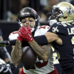 
              New Orleans Saints cornerback Marshon Lattimore breaks up a pass intended for Tampa Bay Buccaneers wide receiver Mike Evans during the first half of an NFL football game in New Orleans, Sunday, Sept. 18, 2022. (AP Photo/Butch Dill)
            