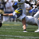 
              Delaware linebacker Liam Trainer (11) reaches for and recovers the ball fumbled by Navy during the first half of an NCAA college football game, Saturday, Sept. 3, 2022, in Annapolis, Md. (AP Photo/Nick Wass)
            