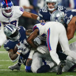 
              Dallas Cowboys running back Ezekiel Elliott (21) is tackled by the New York Giants during the first quarter of an NFL football game, Monday, Sept. 26, 2022, in East Rutherford, N.J. (AP Photo/Frank Franklin II)
            