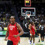 
              Las Vegas Aces guard Chelsea Gray (12) reacts at the end of the team's win over the Seattle Storm in Game 4 of a WNBA basketball playoff semifinal Tuesday, Sept. 6, 2022, in Seattle. (AP Photo/Lindsey Wasson)
            