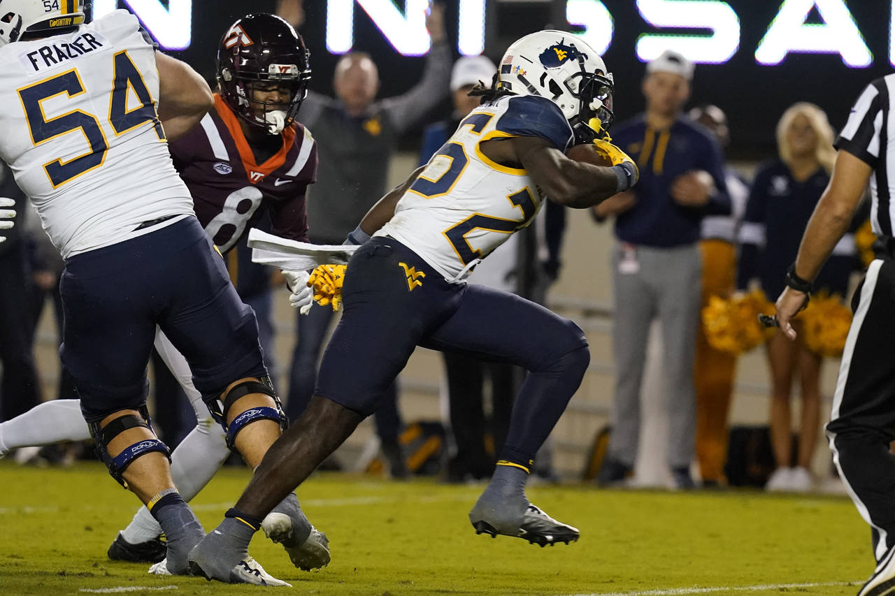 West Virginia running back Justin Johnson Jr. (26) scores a touchdown during the second half of the...
