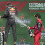 
              Third placed Ferrari driver Charles Leclerc of Monaco, right, sprays sparkling wine on race winner Red Bull driver Max Verstappen of the Netherlands on the podium of the Formula One Dutch Grand Prix auto race, at the Zandvoort racetrack, in Zandvoort, Netherlands, Sunday, Sept. 4, 2022. (AP Photo/Peter Dejong)
            