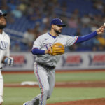 
              Texas Rangers starting pitcher Martin Perez throws to first for the out on a bunt by Tampa Bay Rays' Manuel Margot, left, during the fifth inning of a baseball game Friday, Sept. 16, 2022, in St. Petersburg, Fla. (AP Photo/Scott Audette)
            