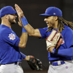 
              Chicago Cubs center fielder Michael Hermosillo high-fives David Bote after the ninth inning of a baseball game against the New York Mets on Wednesday, Sept. 14, 2022, in New York. The Cubs won 6-3. (AP Photo/Adam Hunger)
            
