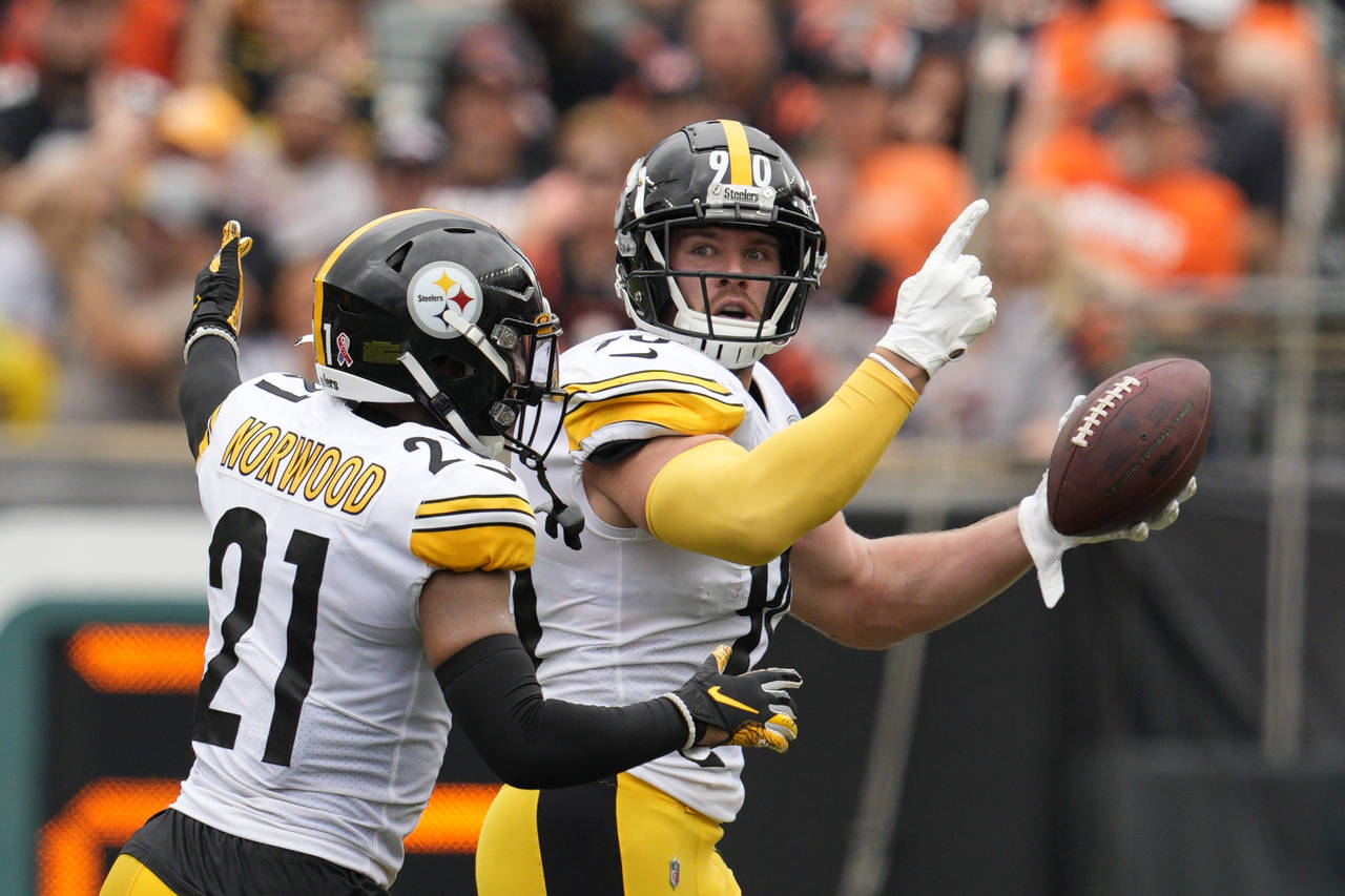 Pittsburgh Steelers linebacker T.J. Watt (90) celebrates after an interception with safety Tre Norw...