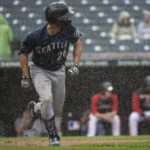 
              Seattle Mariners' Adam Frazier watches his single off Cleveland Guardians starting pitcher Cal Quantrill in the rain, during the fourth inning of a baseball game in Cleveland, Sunday, Sept. 4, 2022. The game was stopped after his hit. (AP Photo/Phil Long)
            