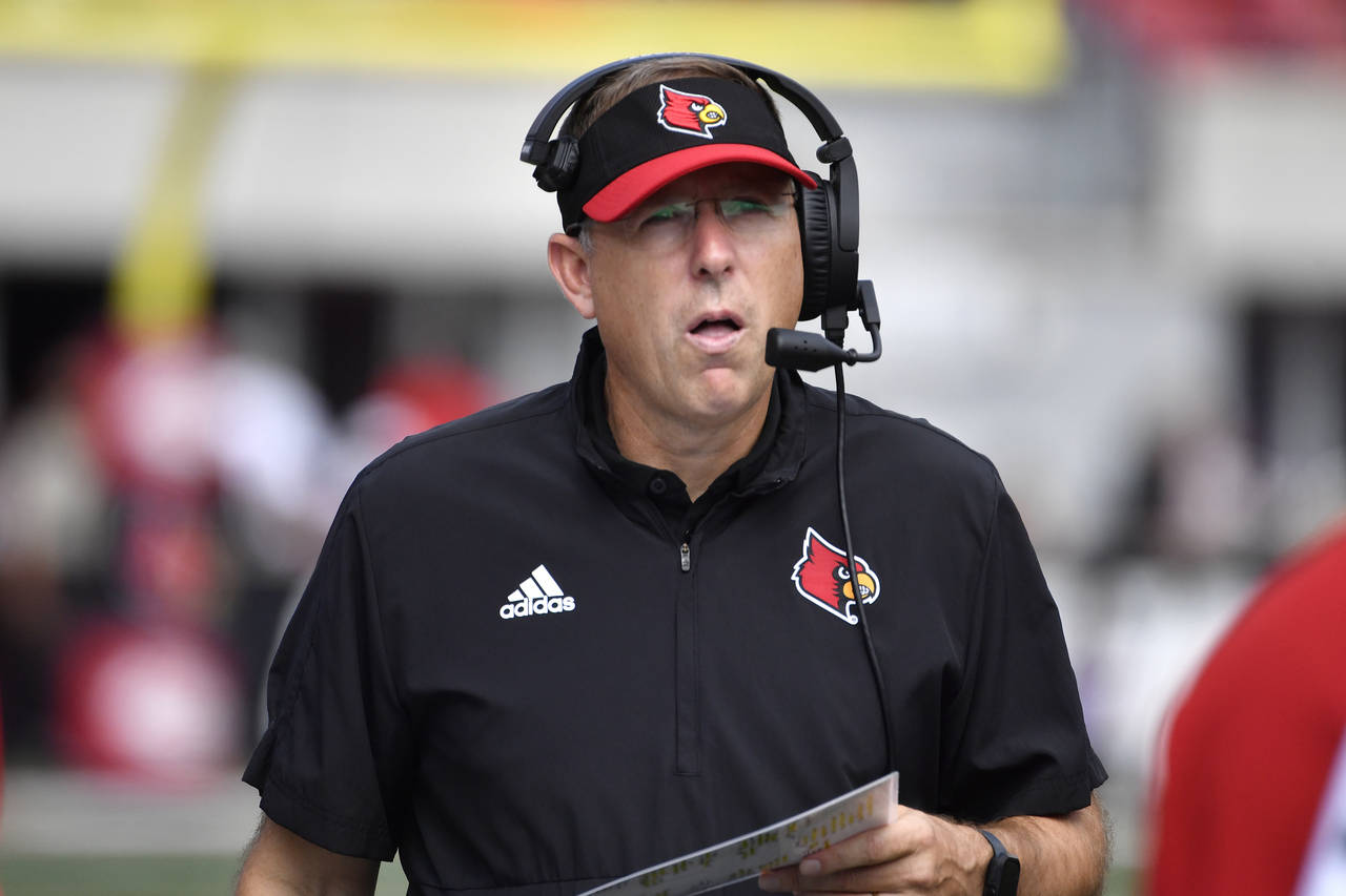 Louisville head coach Scott Satterfield talks on his headset during the second half of an NCAA coll...