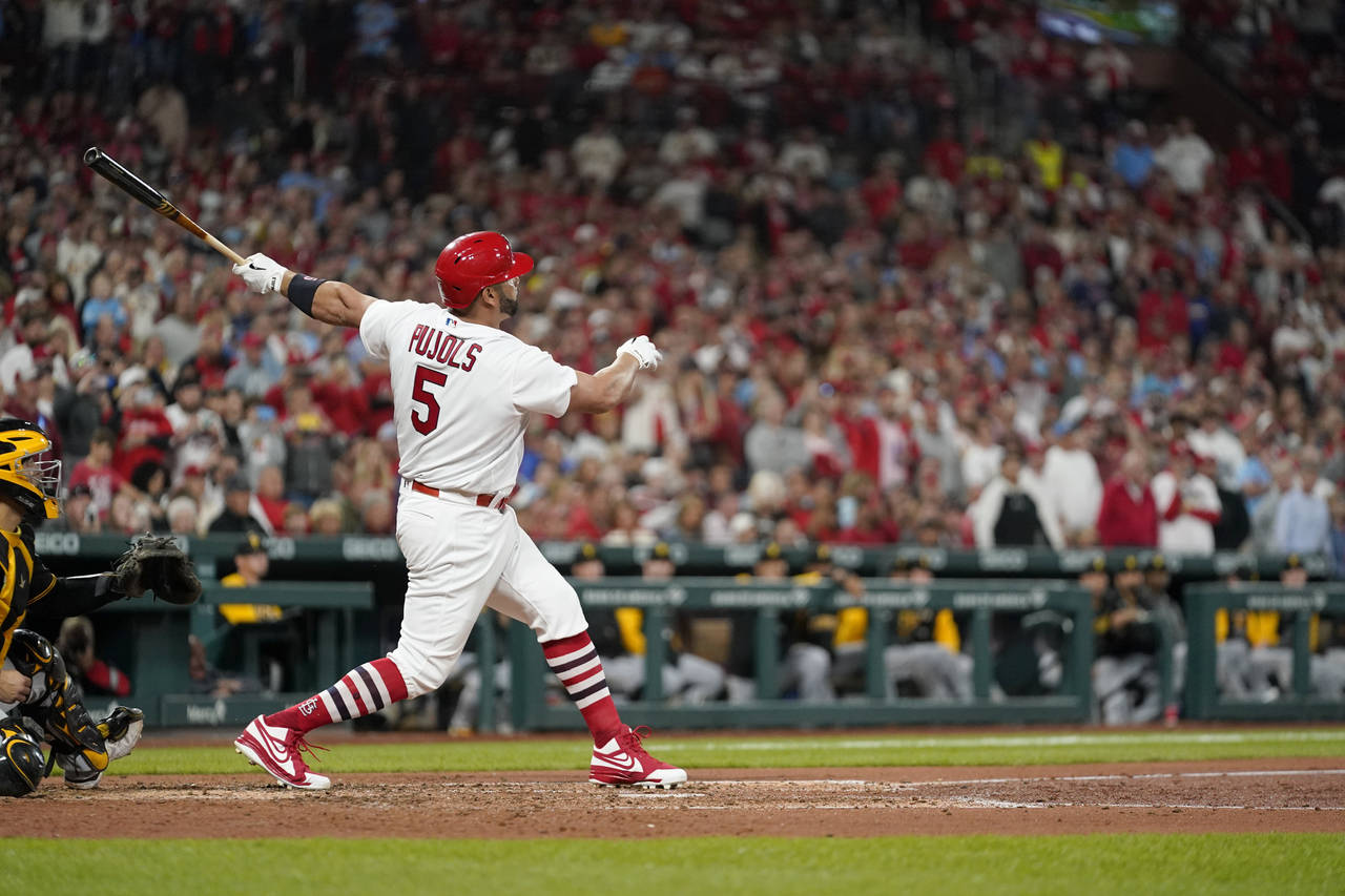 St. Louis Cardinals' Albert Pujols follows through on a solo home run during the fourth inning of a...