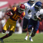 
              Southern California wide receiver Tahj Washington (16) runs the ball against Rice linebacker Treshawn Chamberlain (8) during the first half of an NCAA college football game in Los Angeles, Saturday, Sept. 3, 2022. (AP Photo/Ashley Landis)
            
