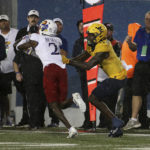 
              Kansas cornerback Cobee Bryant (2) intercepts a pass intended for West Virginia wide receiver Bryce Ford-Wheaton (0) during overtime of an NCAA college football game in Morgantown, W.Va., Saturday, Sept. 10, 2022. (AP Photo/Kathleen Batten)
            