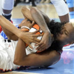 
              Connecticut Sun's Courtney Williams, right, ties up Chicago Sky's Rebekah Gardner for a jump ball during the second half of Game 5 in a WNBA basketball playoff semifinal Thursday, Sept. 8, 2022, in Chicago. (AP Photo/Charles Rex Arbogast)
            