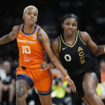 
              Las Vegas Aces guard Jackie Young (0) drives around Connecticut Sun guard Courtney Williams (10) during the first half in Game 2 of a WNBA basketball final playoff series Tuesday, Sept. 13, 2022, in Las Vegas. (AP Photo/John Locher)
            