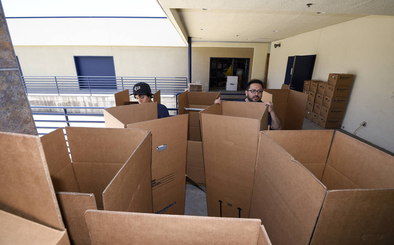 FILE - Movers sorts boxes for packing at the Los Angeles Chargers' facility after NFL football mini...